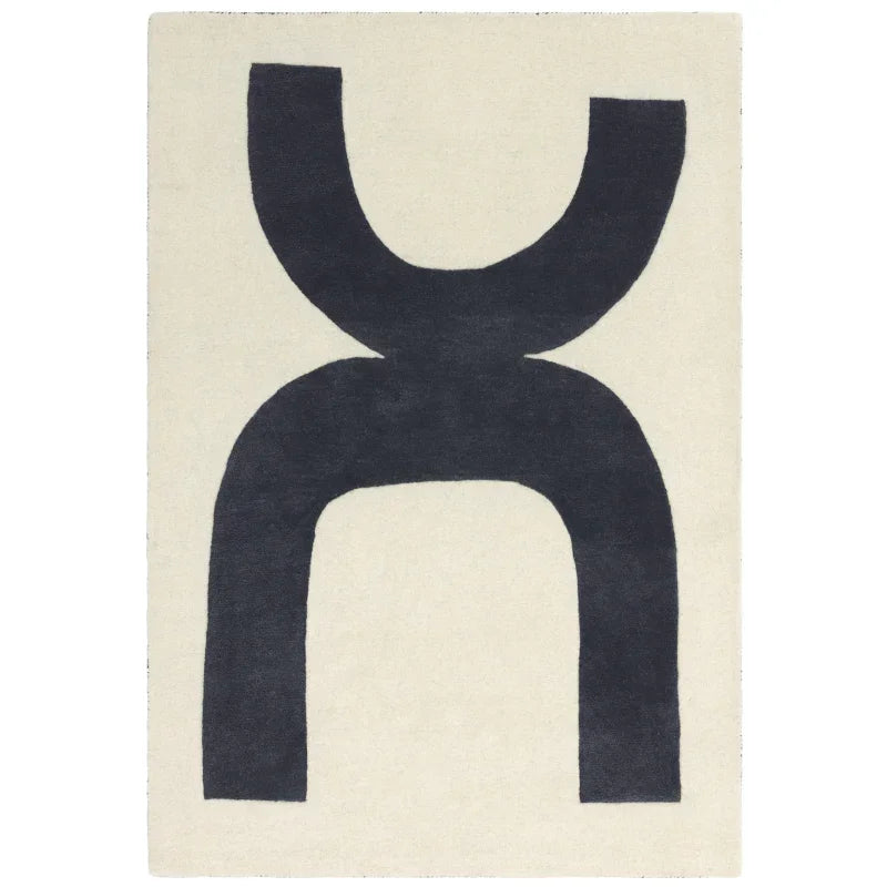 Modern area rug with abstract black geometric pattern on cream background, top-down view