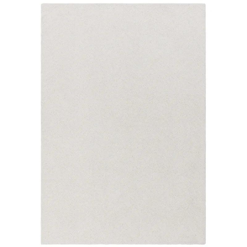 Rectangular cream area rug with soft textured surface