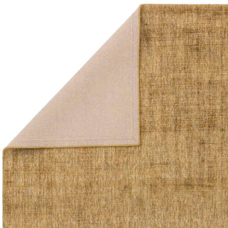 Beige textured area rug with corner folded to show fabric backing