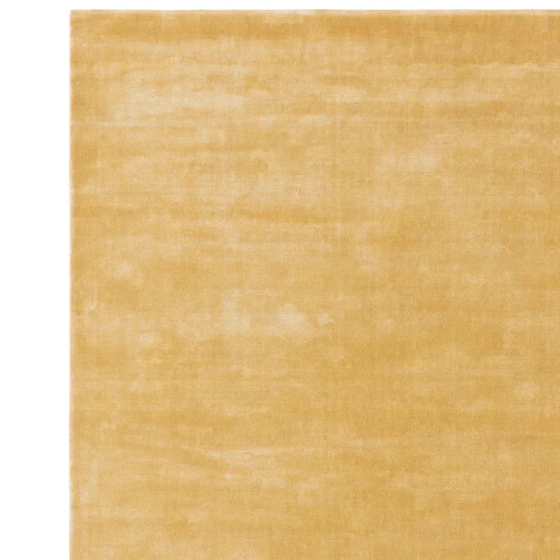 Beige area rug with soft texture and plain design, shown from above