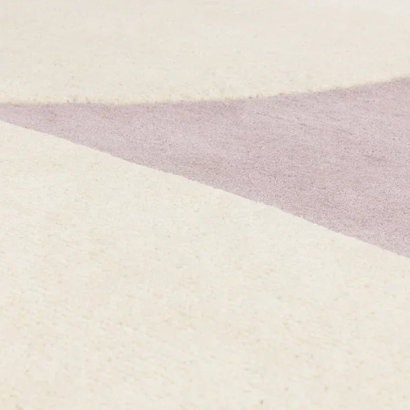 Closeup of cream and light purple geometric rug texture