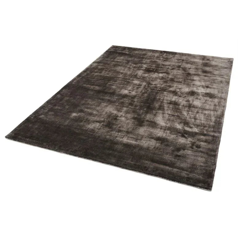 Rectangular dark grey area rug with subtle texture on white background