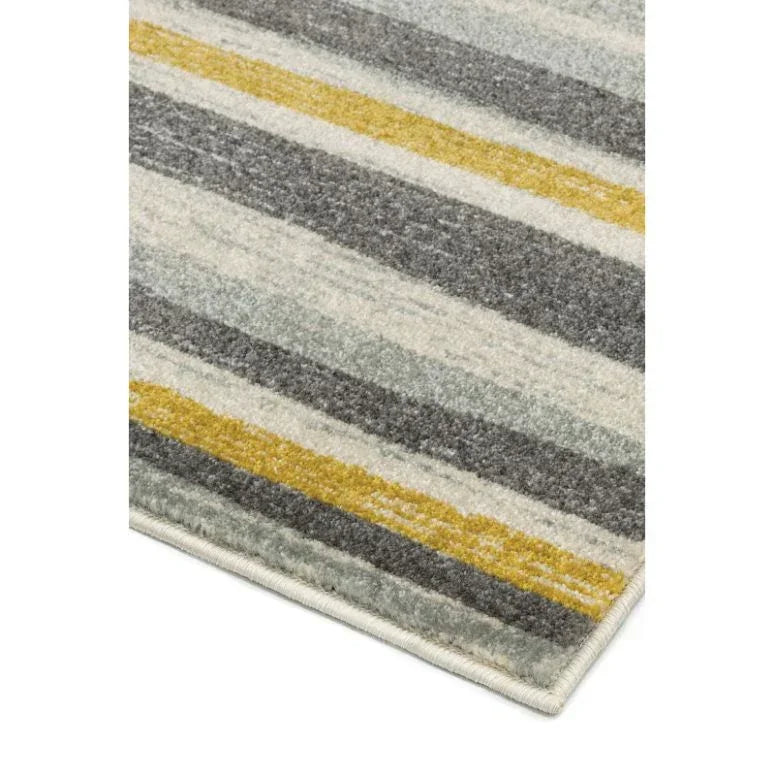 Striped rug corner with grey, yellow, and cream lines, close-up of soft texture