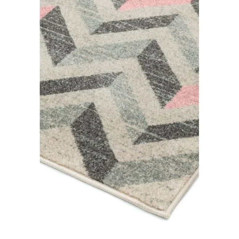 Geometric patterned rug corner in cream, grey, green and pink colors