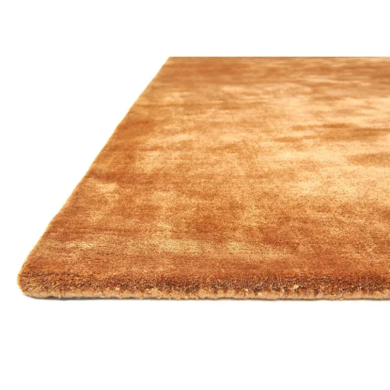 close up of rectangular brown area rug with soft pile and smooth edging