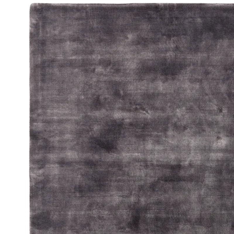 Charcoal grey velvet rug with plush texture, cropped corner view