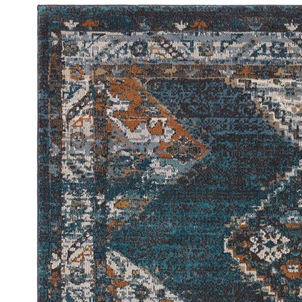 Corner detail of blue and orange patterned rug with geometric border design