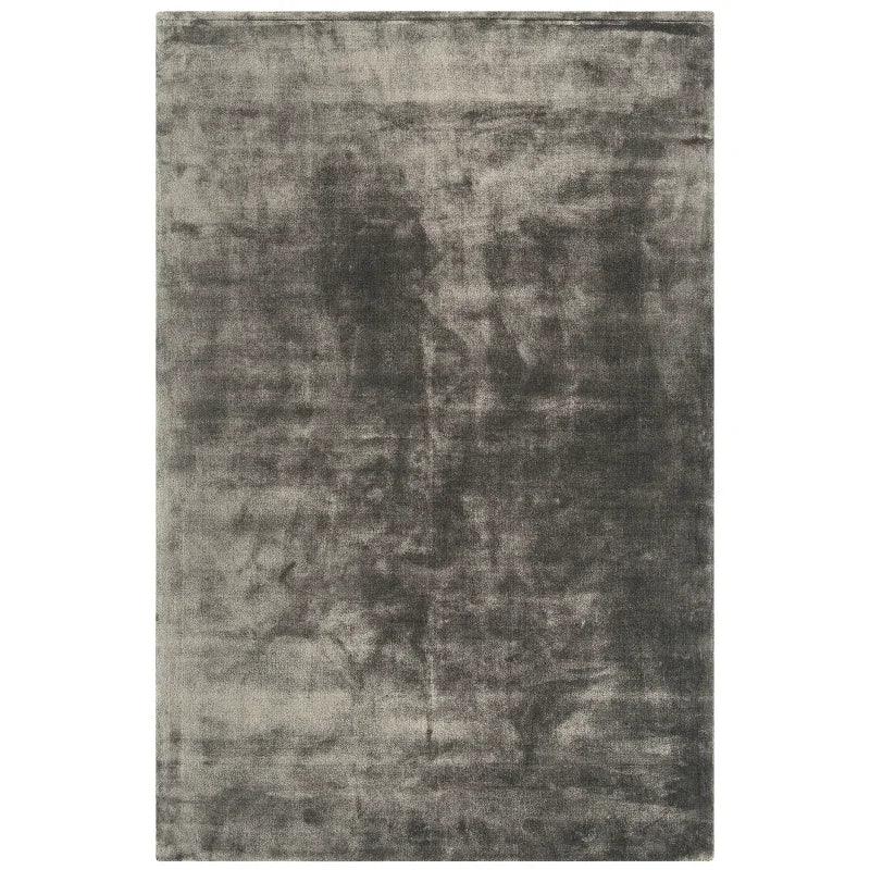Grey velvet rug with plush texture and rectangular shape on white background