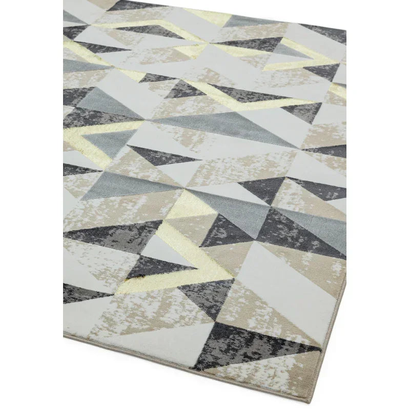 Geometric area rug with grey, beige and gold triangles on a neutral background