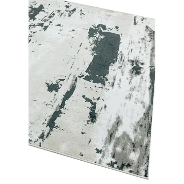 Abstract grey and white area rug with distressed pattern, corner view on white background