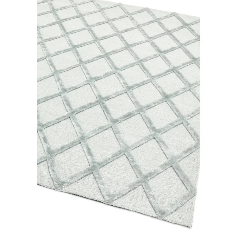 Light grey area rug with raised diamond geometric pattern on soft fabric