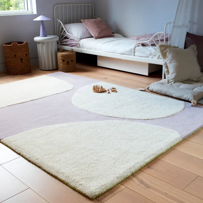 Modern area rug with abstract cream shapes in cosy bedroom with wooden floor