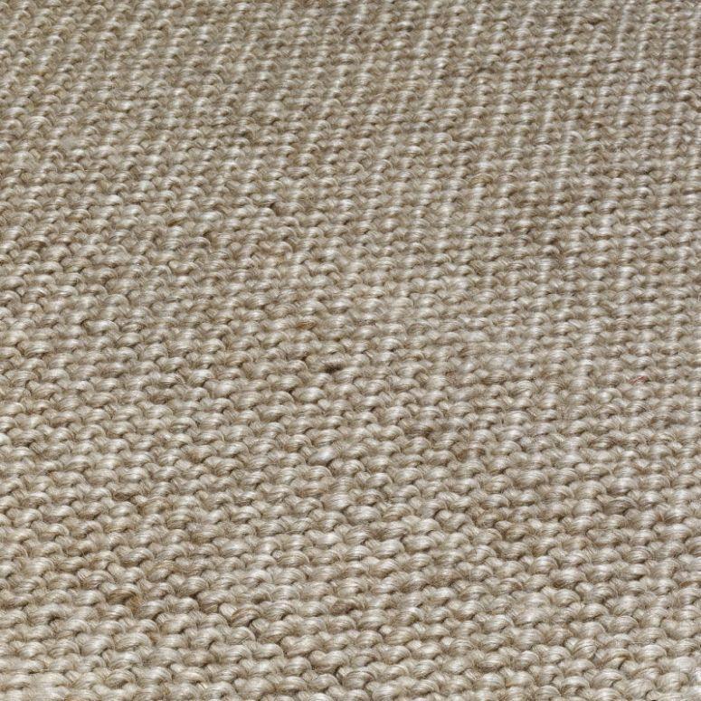 Close-up of beige woven rug texture highlighting natural fiber material