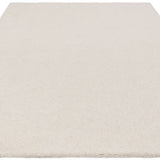 Rectangular cream wool rug with short pile texture viewed from low angle