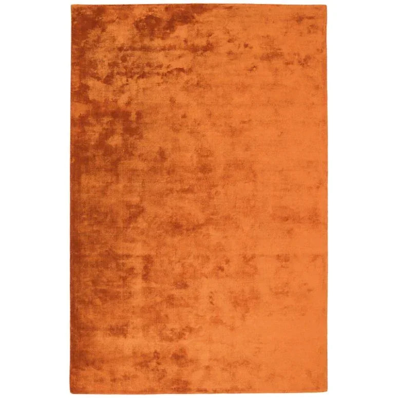 Rectangular orange area rug with soft textured finish, photographed from above