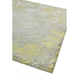 Abstract yellow and grey area rug with textured pattern, close-up of corner