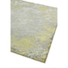 Abstract yellow and grey area rug with textured pattern, close-up of corner