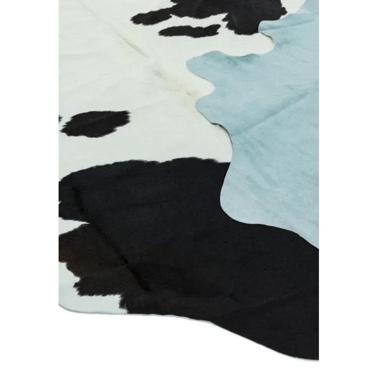 Cowhide rug with black, white, and light blue pattern, angled close-up view