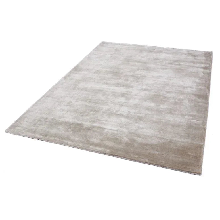 Rectangular beige area rug with soft pile on white background