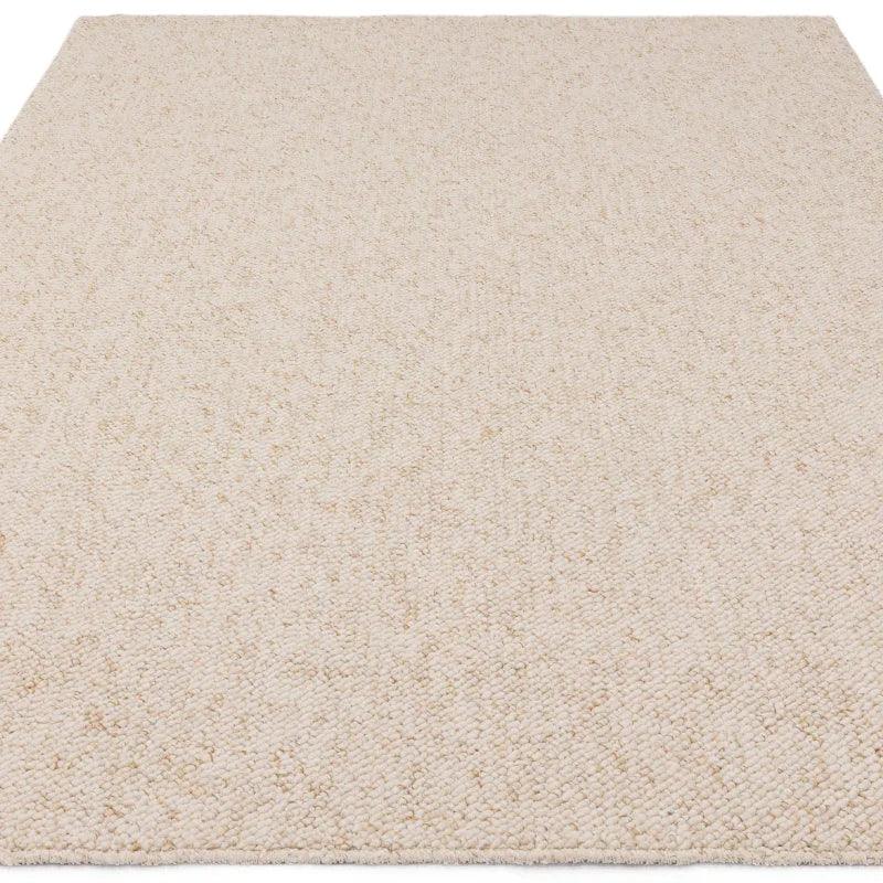 Beige wool textured rug with chunky weave in a rectangular shape