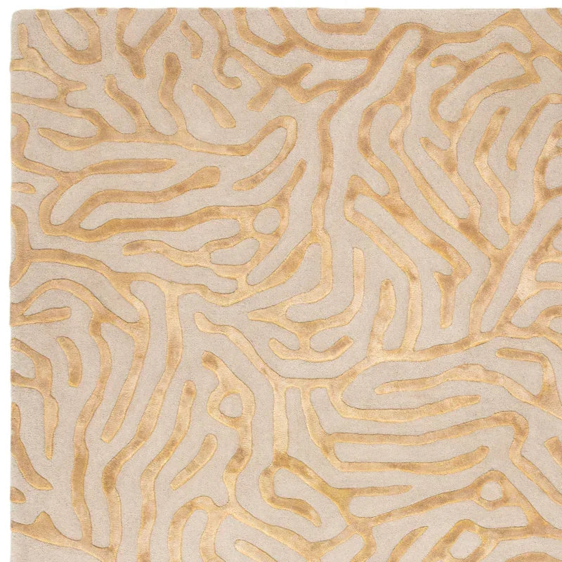 Beige and gold patterned rug with abstract raised lines and soft textured surface