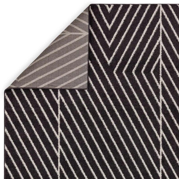Black chevron striped rug with contrasting underside corner detail visible
