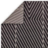 Black chevron striped rug with contrasting underside corner detail visible
