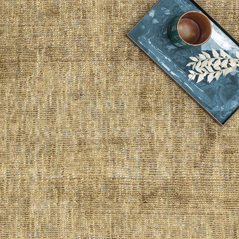 Textured natural jute rug with tray holding cup and decorative leaves