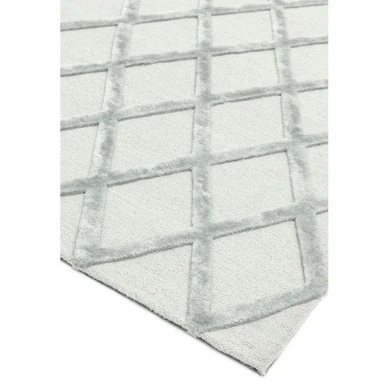Grey geometric patterned rug with raised diamond texture on a light background