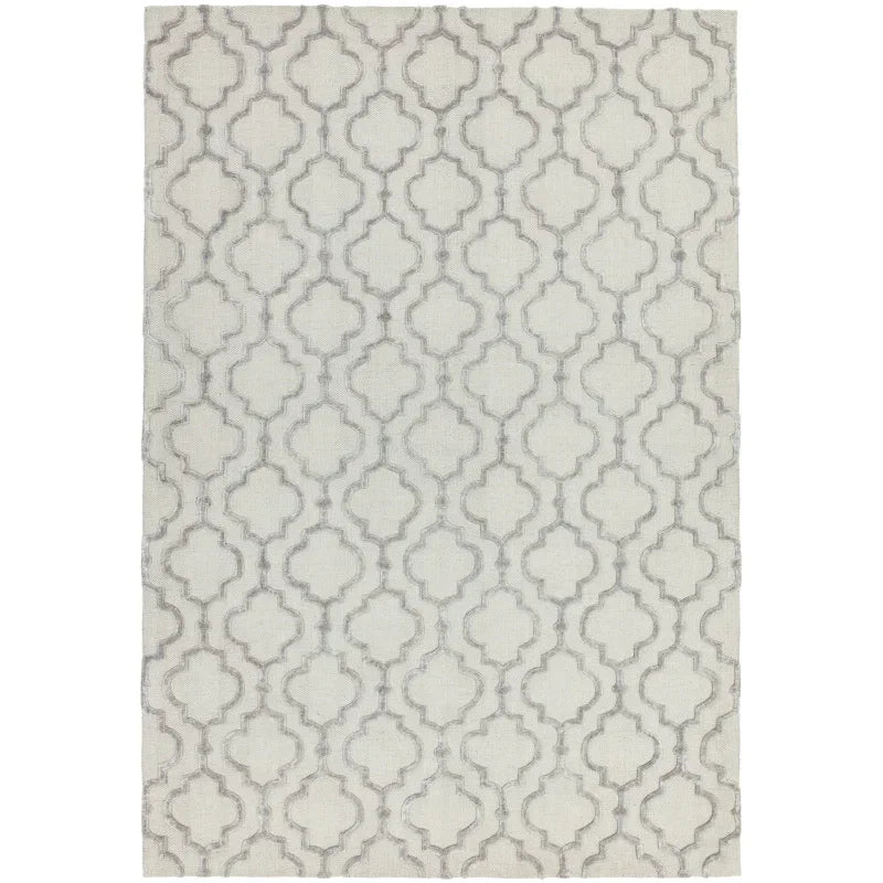 Cream area rug with grey geometric trellis pattern