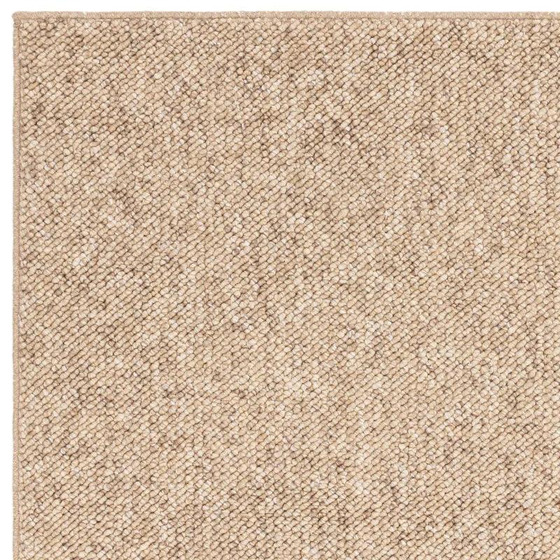 beige woven rug corner detail showing textured loop pile fabric