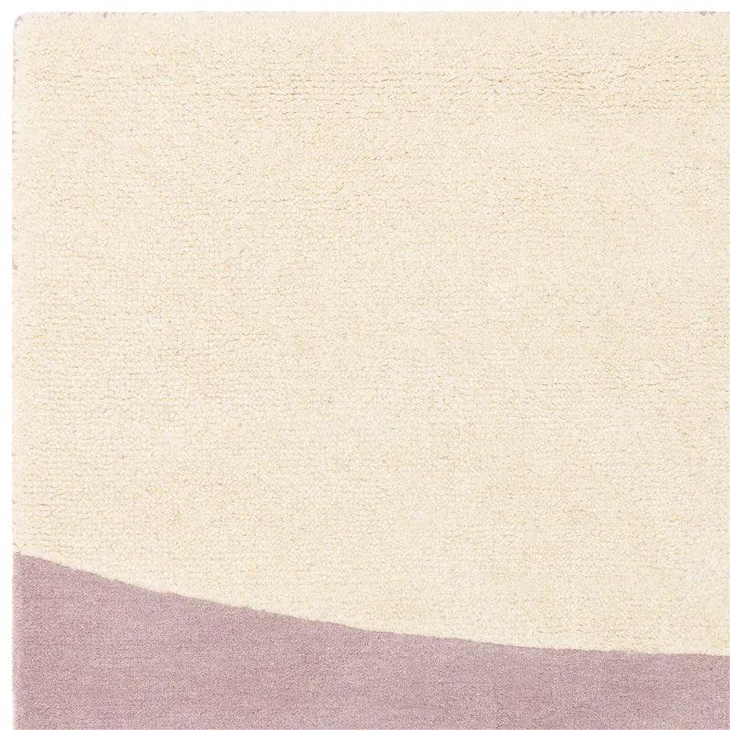 cream and mauve area rug with abstract curved pattern, textured wool surface detail