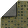Green polka dot rug with textured pattern and visible corner showing backing