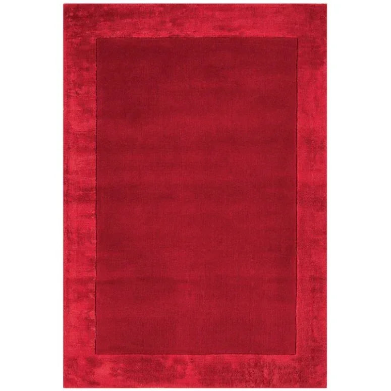 Red bordered area rug with solid center and plush texture
