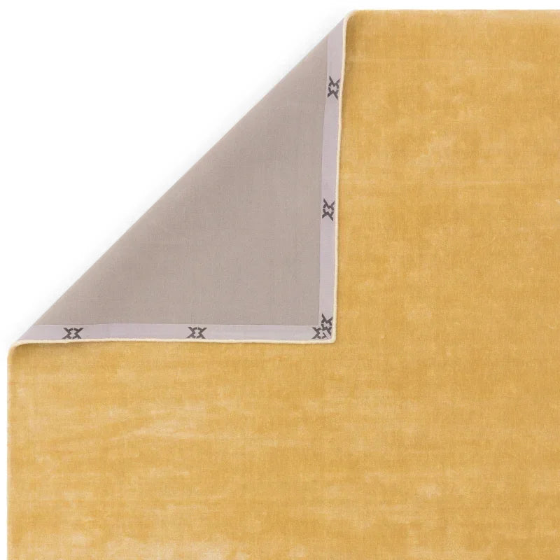 Mustard yellow velvet rug with grey corner and stitched border detail