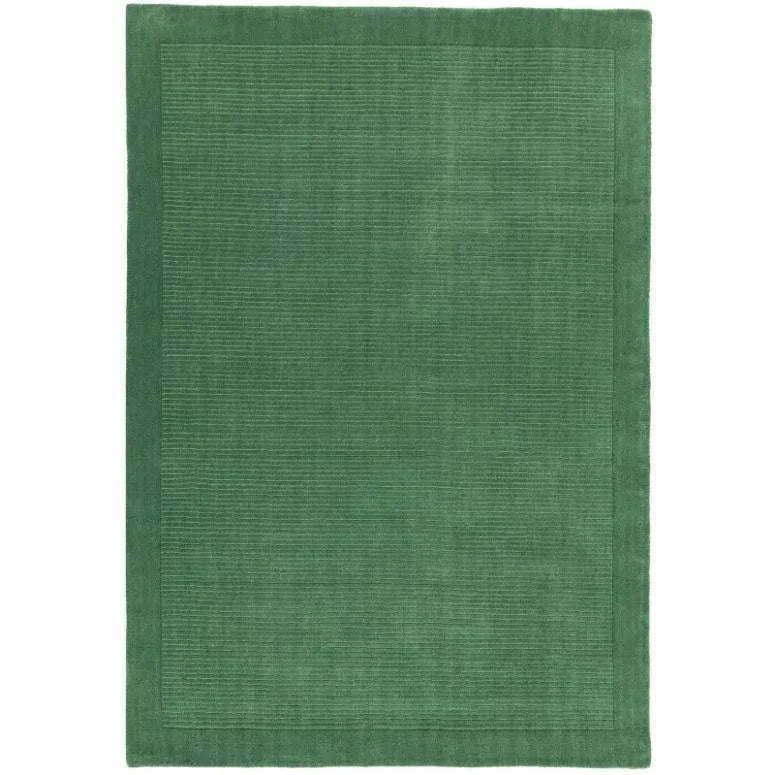 Green wool area rug with subtle textured border and minimalist design