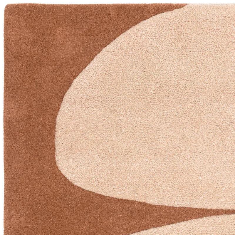 Beige and brown modern area rug with abstract pattern closeup