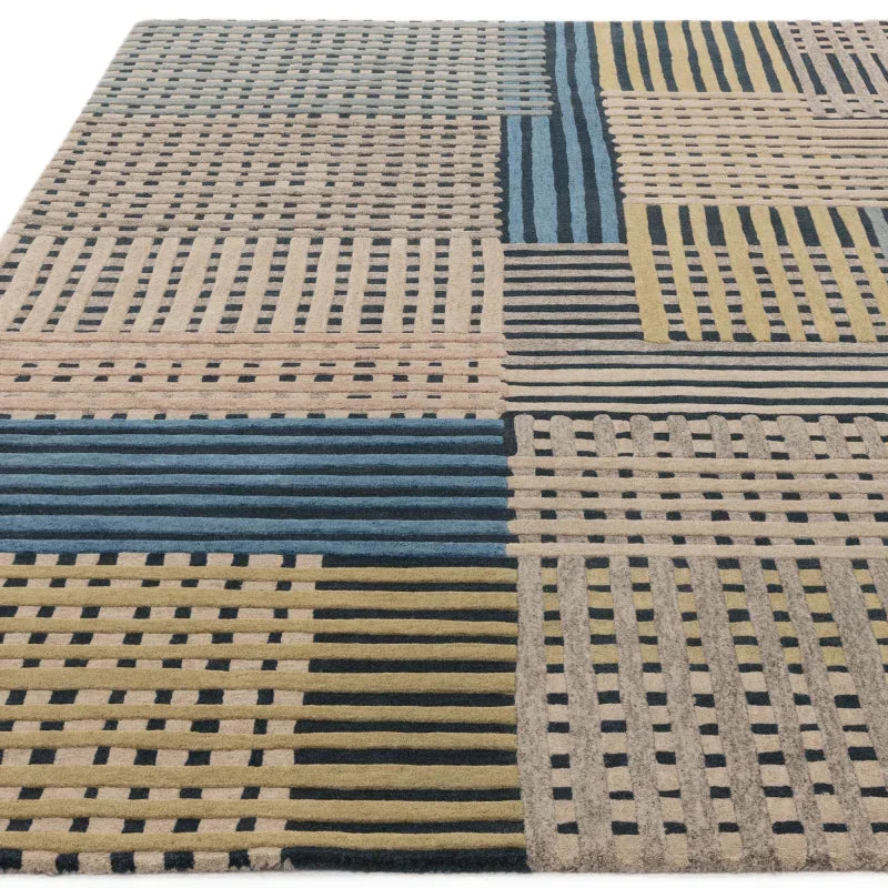 Geometric patterned area rug with blue, beige, grey, and yellow stripes and blocks