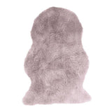 Blush pink sheepskin rug with soft fluffy texture on white background