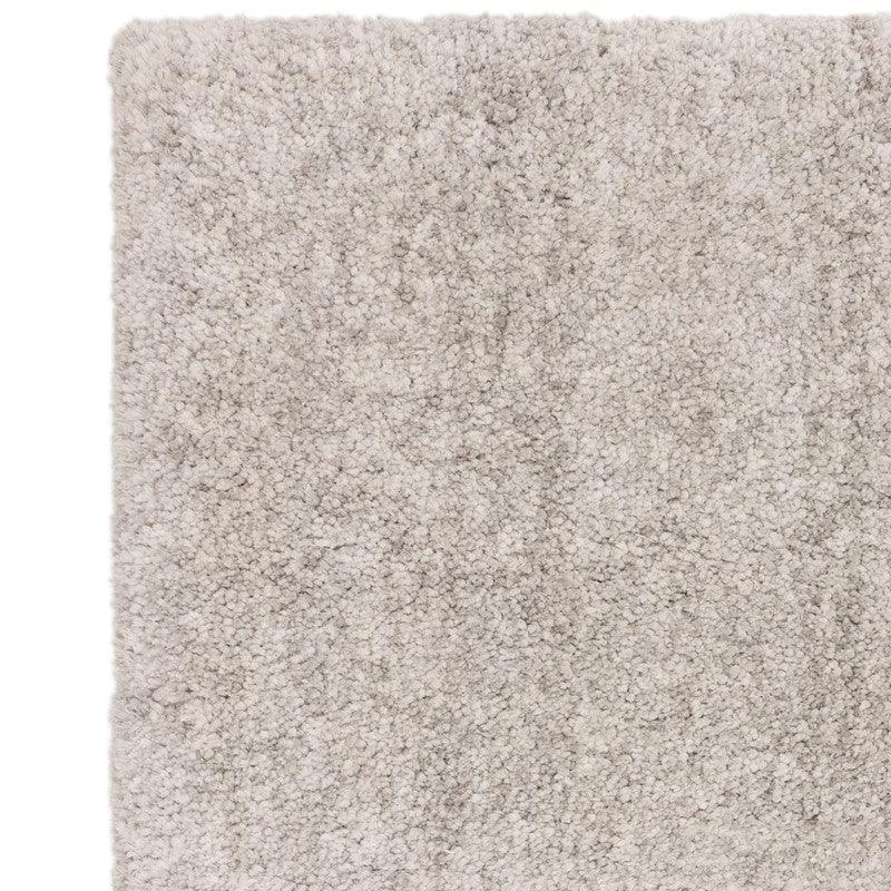 Close-up of light beige shaggy rug with soft pile texture