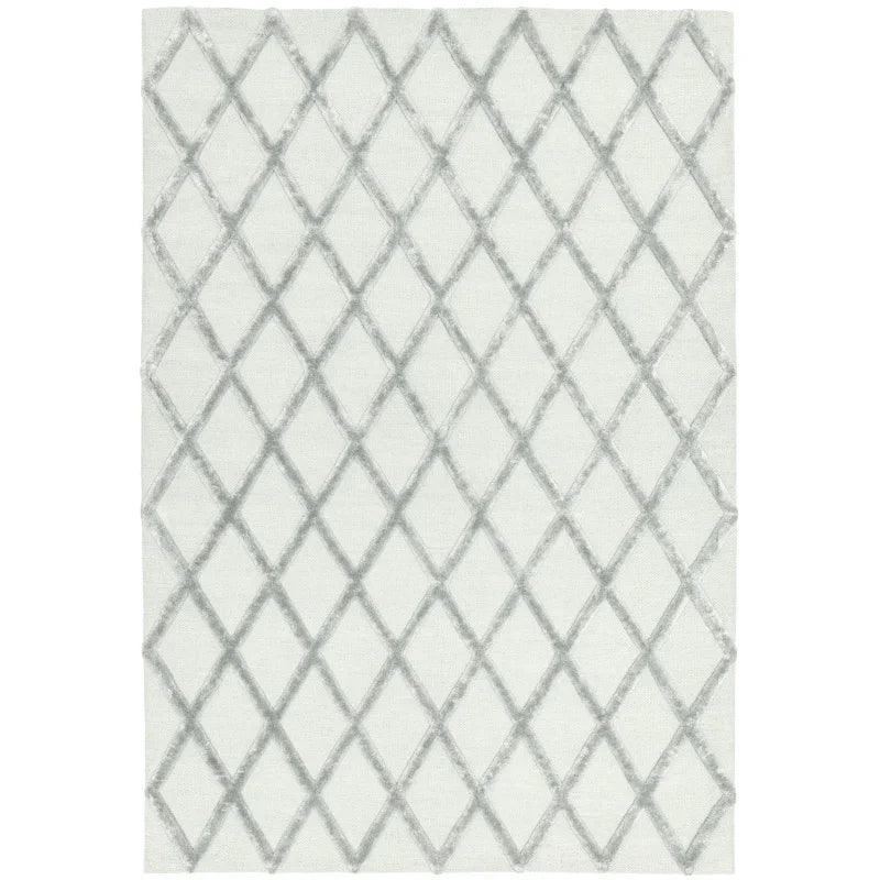 Modern area rug with grey diamond lattice pattern on white background