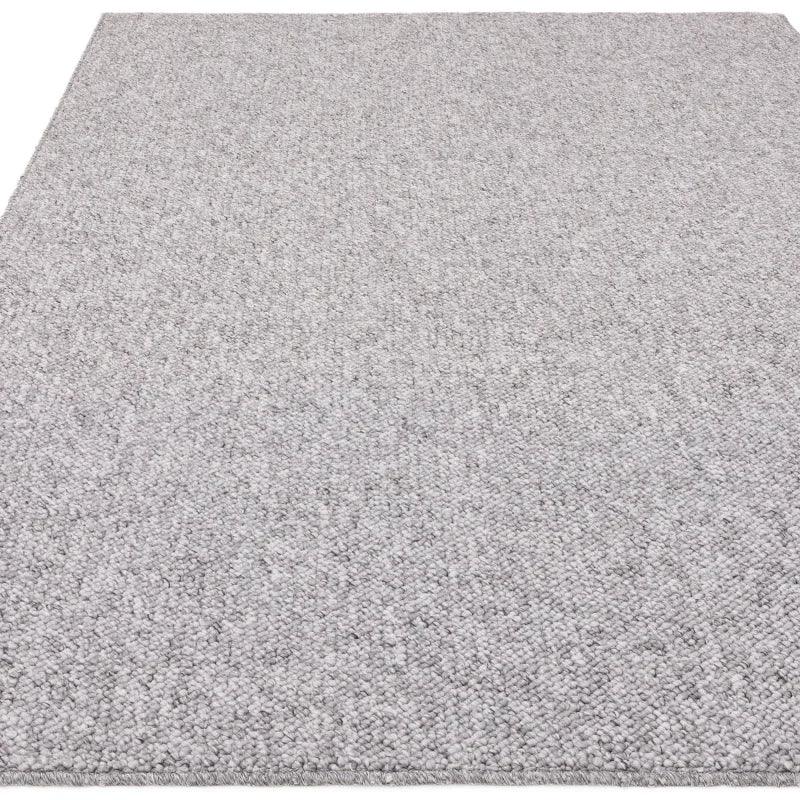 Textured light grey area rug with loop pile detail, shown from corner angle