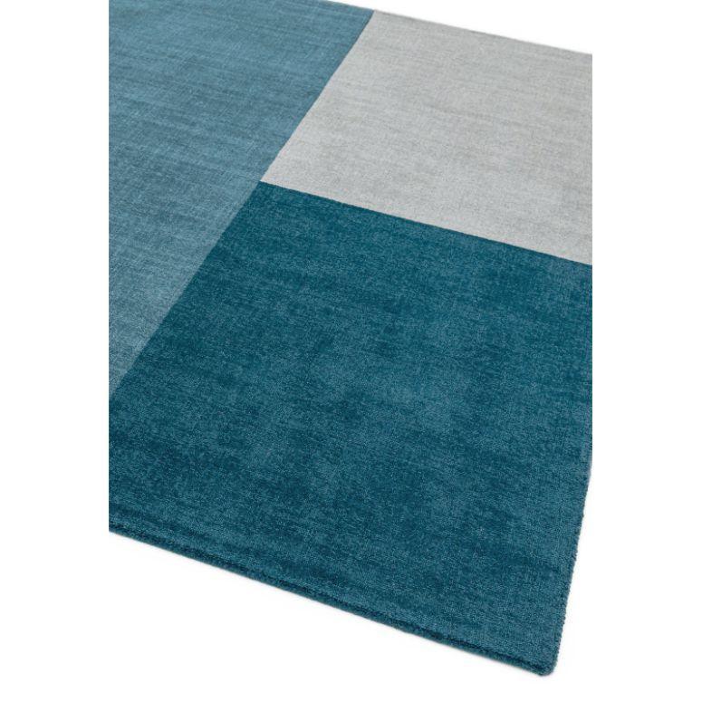 Blue and grey color block area rug with square pattern and soft textured surface