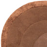 Round brown rug with textured concentric circles, close-up corner view