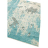 Blue and cream abstract area rug with textured pattern, angled corner view