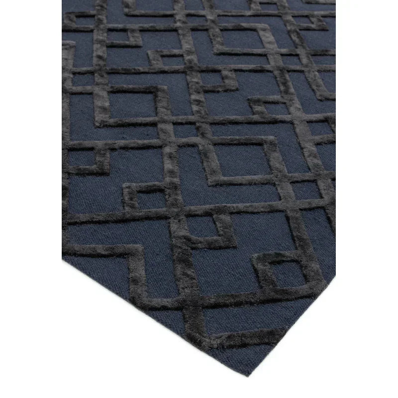 Navy and charcoal geometric rug with raised pattern, corner angle view