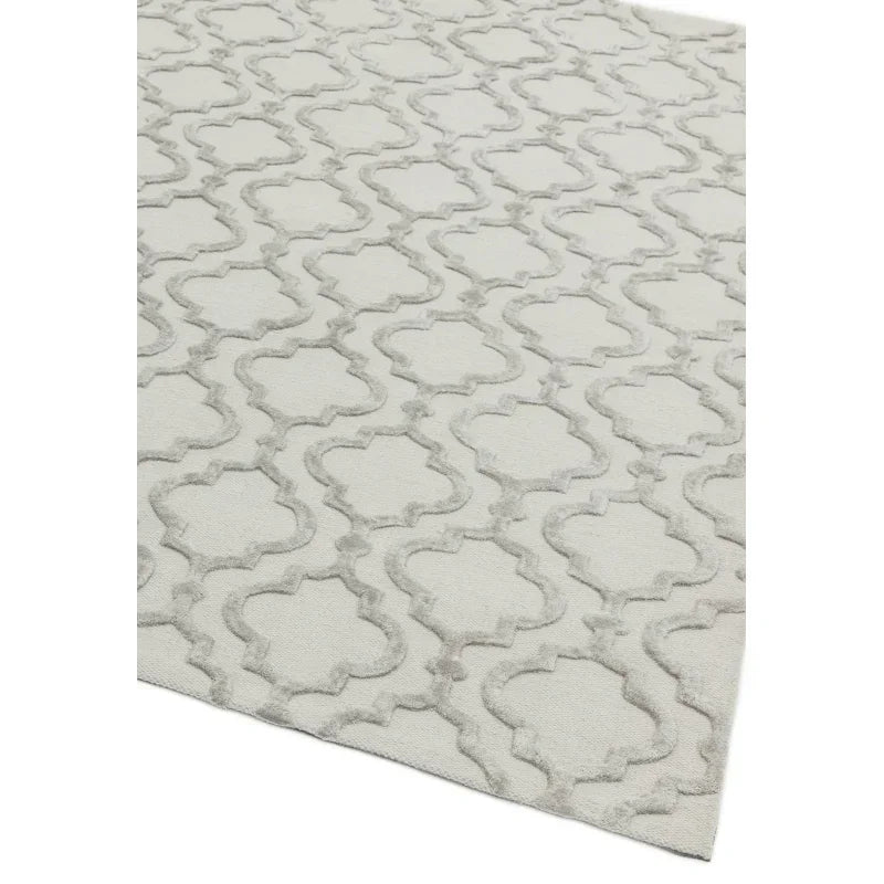 Light grey patterned rug with raised trellis design, shown from angled corner view