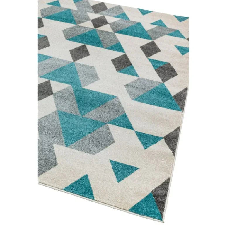 Modern geometric rug with blue, grey, and white triangles on a cream background