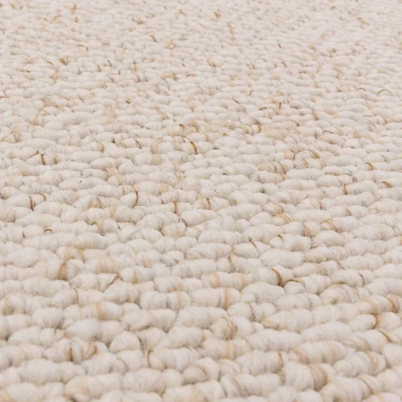 Close up of cream wool loop pile carpet texture
