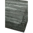 Corner of a modern grey area rug with textured pattern and soft finish